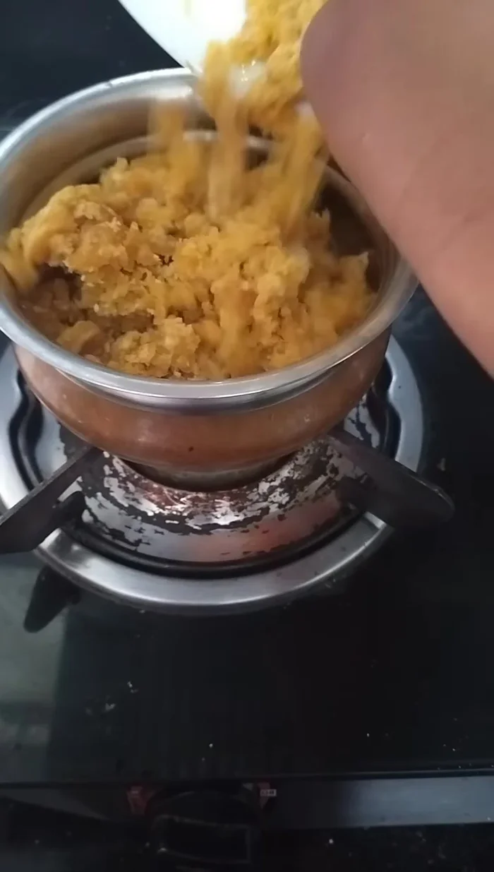 In a separate pan, add one cup of jaggery and half a cup of water. Mix well until dissolved.
