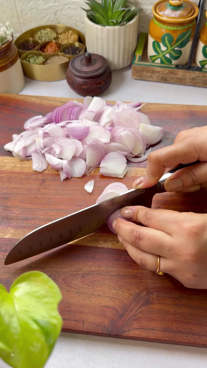 Slice onions into strips. Add ginger, garlic, green chilies, celery, spices, and boiled potatoes. Mix well.