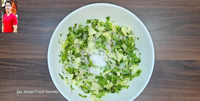 In a bowl, mix the chopped vegetables with salt, red chili powder, turmeric powder, whole coriander, cumin seeds, and Kasuri Methi. Massage the spices into the vegetables to release their aroma and flavor.