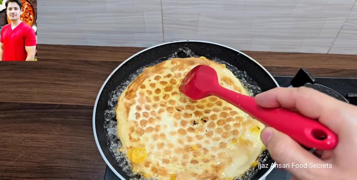 Deep fry the naan in medium-hot oil until golden brown and cooked through, flipping halfway to ensure even cooking.