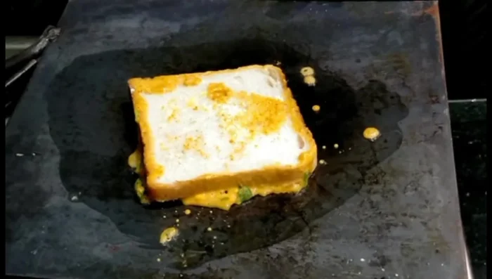 Place the bread (batter-side down) onto the hot pan. Cook until golden brown. You don't need to apply batter to both sides.
