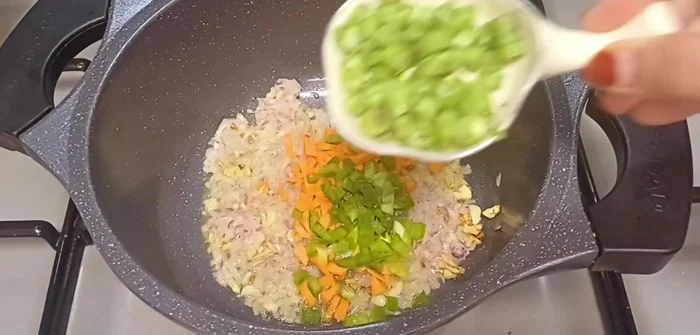 Add 2 tablespoons each of carrots, capsicum, beans, broccoli, corn, and mushrooms (or your preferred vegetables).