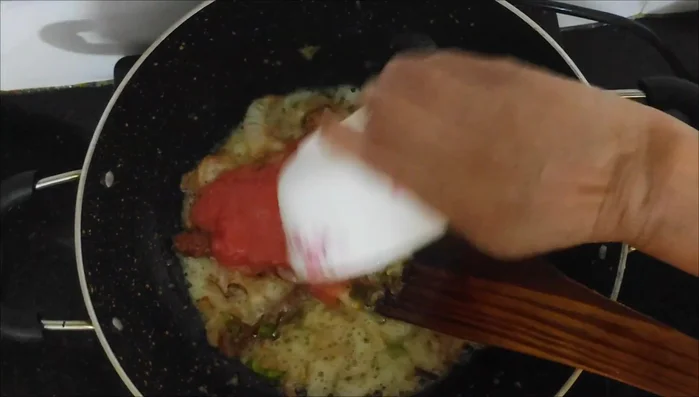 Add ginger-garlic paste, tomato paste, and spices (turmeric, chili powder, garam masala, sugar). Sauté well.