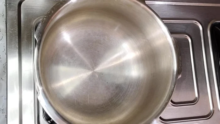 Boil the mango pieces in a cooker with a bay leaf, a little salt, and one cup of water until soft (approximately two whistles).