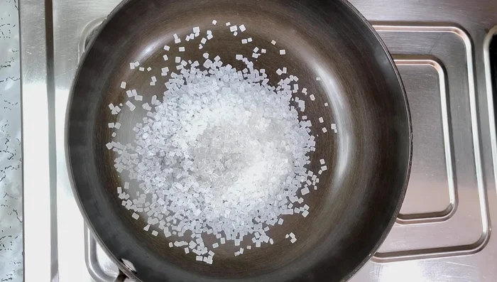 In a pan, dissolve 1/2 cup sugar in 2-3 spoons of water over medium heat.