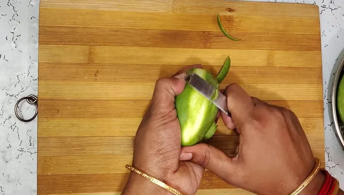 Cut the peeled mangoes into small pieces, ensuring the seeds are removed.