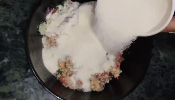 In a separate bowl, mix semolina, curd, and water. (130.08)