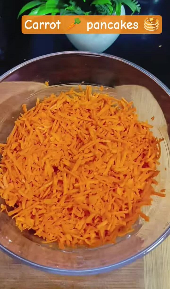 Grate three carrots.