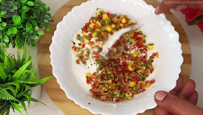 Add the cooled tempered vegetables to the rested batter and mix well.
