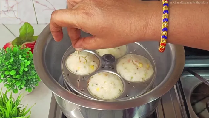 Check for doneness with a toothpick. Once cooked, let the idlis cool slightly before removing them from the molds.