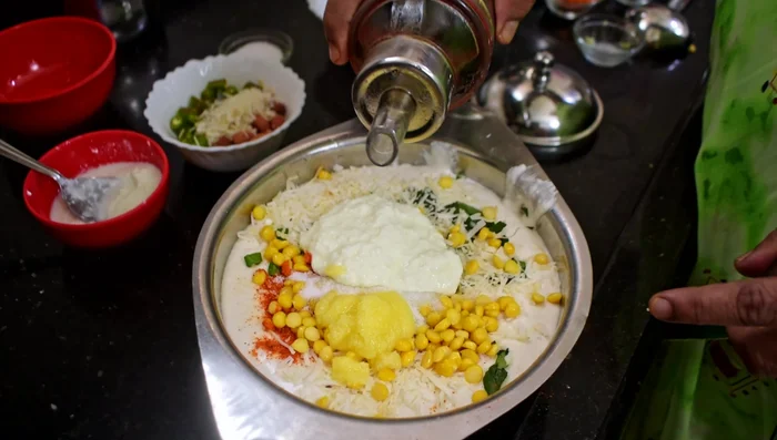 Grease the idli molds with oil and ghee.