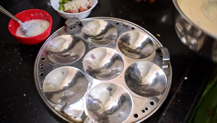 Fill the idli molds with the batter.