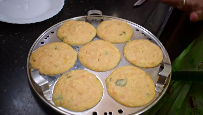 Let the idli cool slightly before removing from molds.