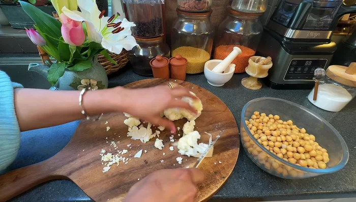Prep vegetables: chop cauliflower into bite-sized pieces, trim and slice green beans.
