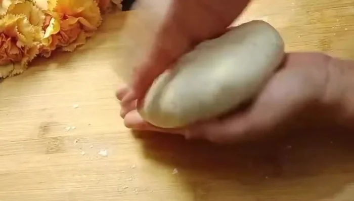 Assemble the naan: Roll each portion into a circle. Add the potato stuffing to the center. Seal the edges, and gently roll out again to flatten (128.479).