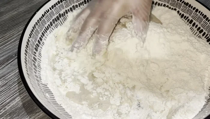 Gradually add the yeast mixture to the flour mixture, kneading until a smooth dough forms.