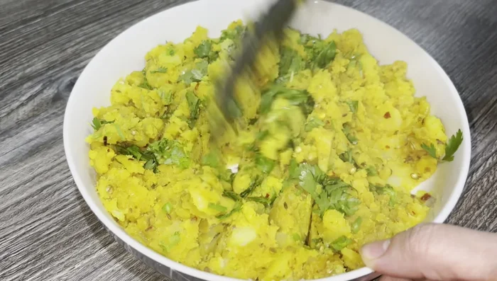 Add fresh coriander and mix into the potato mixture.