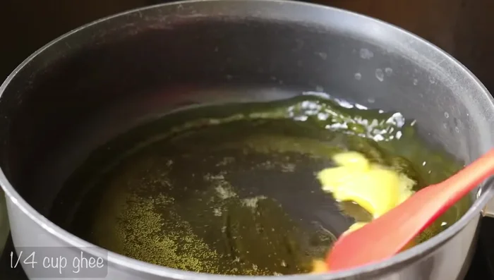 Heat a pan and add 1/4 cup of ghee. Once hot, add 1 cup of wheat flour and fry on low flame until golden brown.