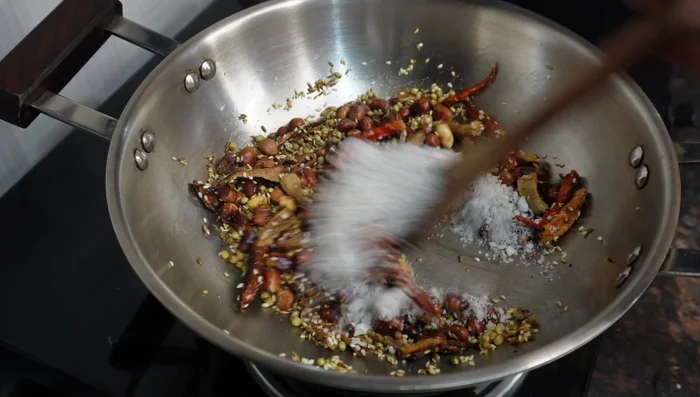 Add grated coconut and roast briefly until fragrant as coconut burns easily. Add the dried curry leaves and mix well. Turn off heat once leaves are slightly warmed.