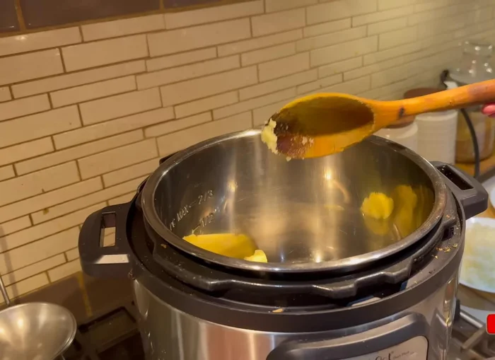 Heat ghee or oil in a pressure cooker. Add chopped onions and sauté until golden brown (135.92).