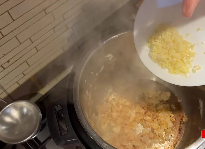 Add crushed garlic and ginger paste and fry for a while (199.519).