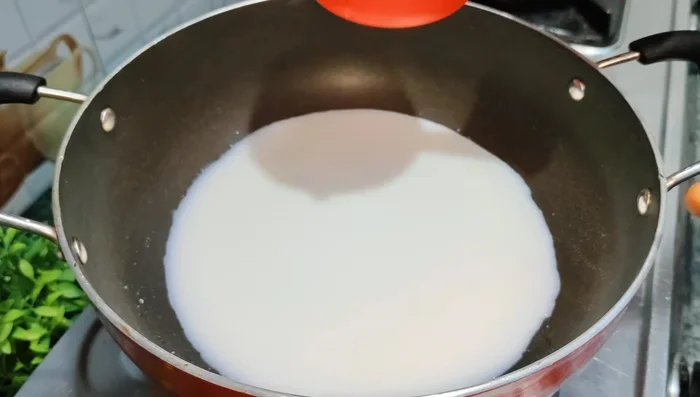 Heat milk in a pan until boiling.