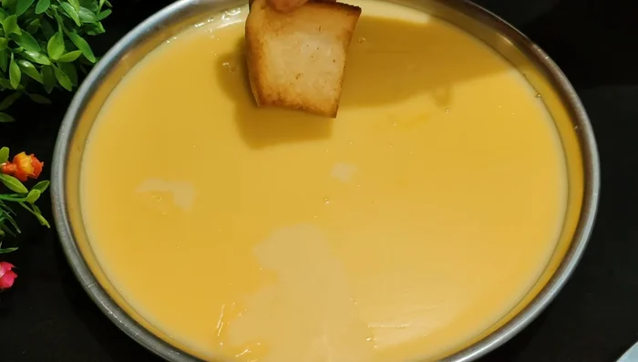 Dip the fried bread pieces into the cooled custard milk mixture, ensuring they are half-submerged.