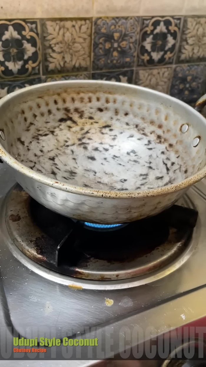 Turn on the stove and when the pan is hot enough, add a quarter cup of peanuts and fry until golden brown.