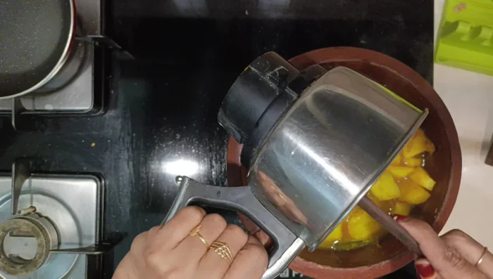 Add the ground masala to the cooked pumpkin. Mix well. Let it boil once on medium flame. Check for spices and salt. Rinse the mixer jar with a little water and add it to the curry. Adjust consistency. (134.28)