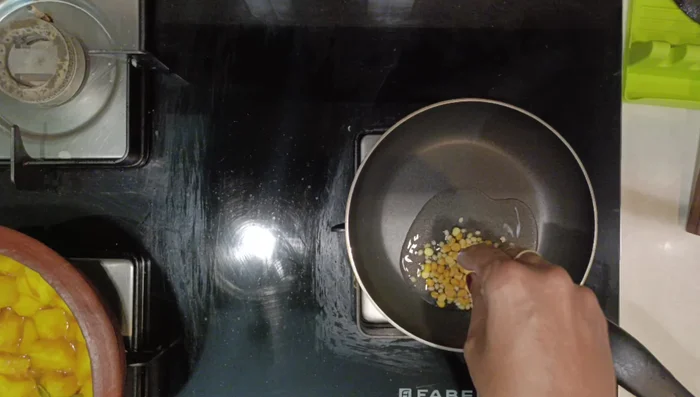 Roast the masala ingredients: In a fry pan, heat coconut oil. Add urad dal, chana dal, coriander seeds, fenugreek seeds, cumin seeds, dry red chilies, and curry leaves. Roast on low flame until dals turn light brown. (89.799)