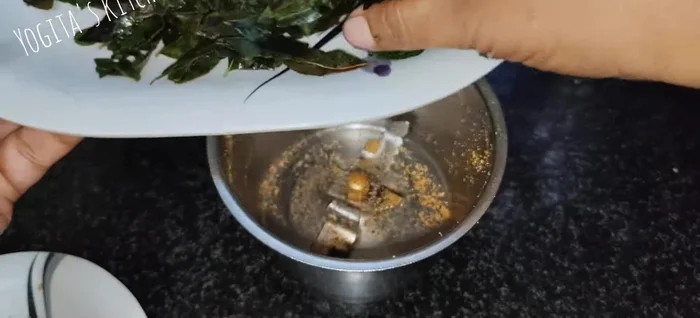 Grind the cooled curry leaves into a coarse powder using pulse mode.