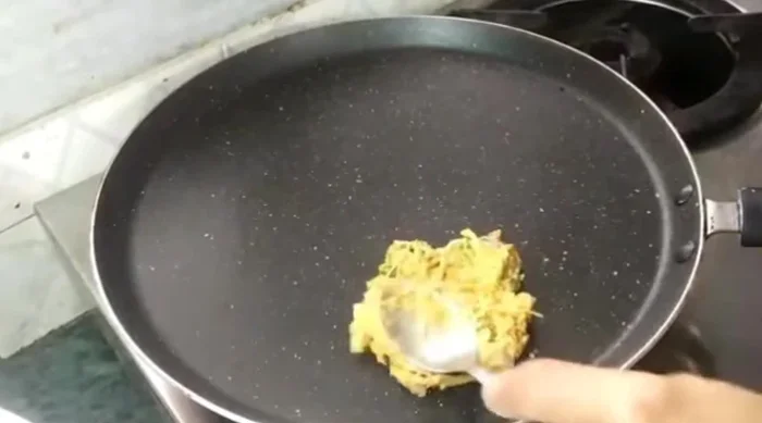 Heat a pan. Take a spoonful of the barley batter and spread it thinly on the hot pan.