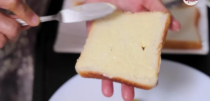 Spread butter and chutney on another slice of bread and place it on top.