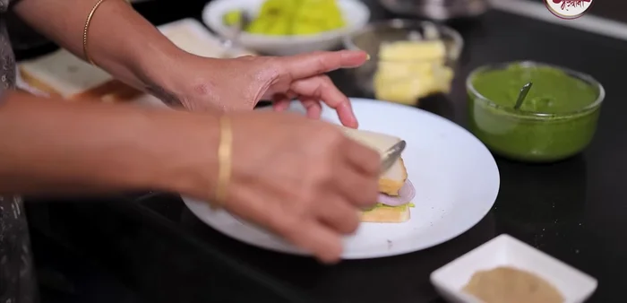 Spread butter on the top of the sandwich.