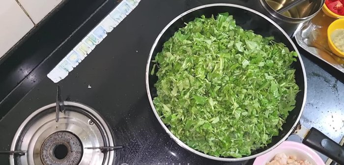 Add the chopped fenugreek to the pan to soften and drain excess water.