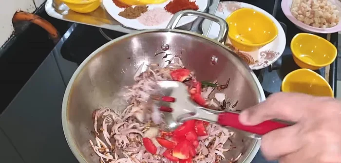 Add ginger-garlic paste, tomatoes, and all the spices (garam masala, red chili powder, cumin powder, turmeric powder, coriander powder, Kashmiri red chili powder). Fry well until oil separates.