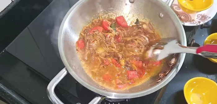 Add half a bowl of water to fry the spices. Let it simmer until tomatoes melt and the water dries up.