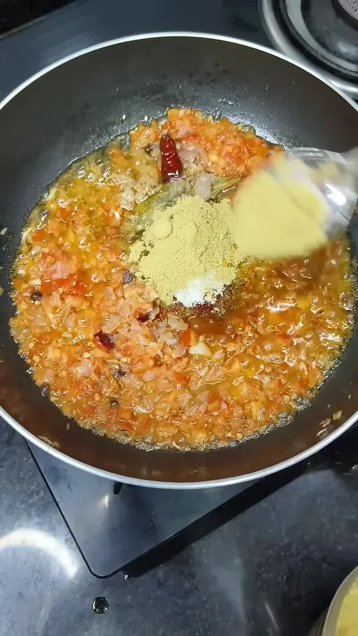 Add turmeric powder, crushed red chili powder, red chili powder, black pepper powder, salt, and coriander powder. Fry for 1 minute.