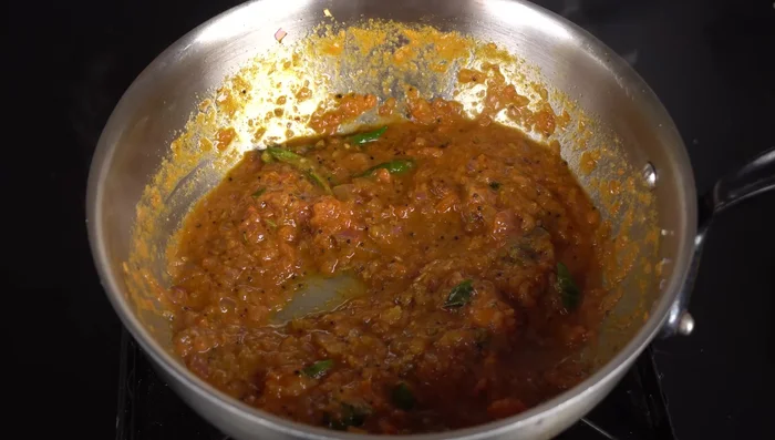 Add blended tomatoes to the pan.