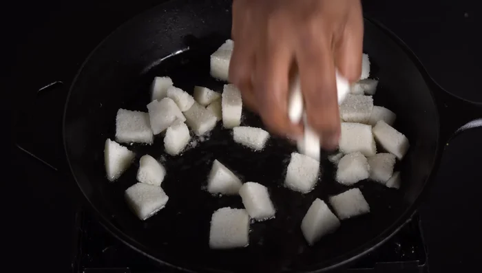 Add the idli pieces and roast until golden brown. Using a non-stick pan will prevent oil absorption