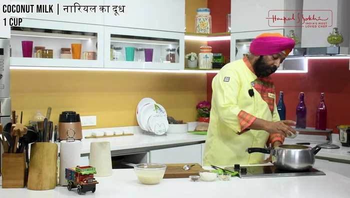 Add mango puree, coconut milk, sugar, salt, and turmeric powder to the pressure cooker. Mix well.