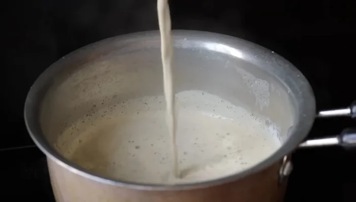 Pour the tea through a strainer into a cup, ensuring thorough draining.