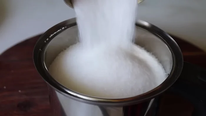 Grind 1 cup of unroasted semolina and ¾ cup (or ½ cup) sugar into a fine powder using a mixer jar.