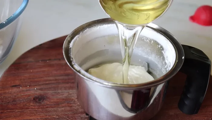 In the mixer jar, combine ¼ cup yogurt, ¼ cup oil, 1 tablespoon ghee (or butter), 1 teaspoon vanilla essence, and ½ cup boiled and cooled milk.