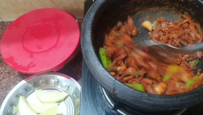 Add the spice powders (coriander, turmeric, cumin) and fry for 30 seconds.