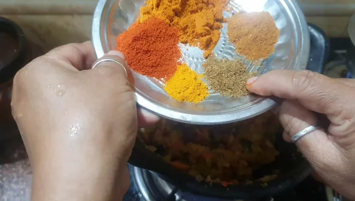 Add cumin powder, turmeric powder, chili powder, coriander powder, and garam masala. Mix well.