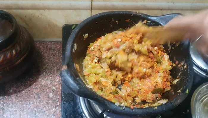 Stir until the raw smell of spices disappears.