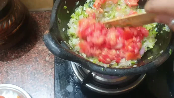 Add chopped tomatoes and sauté until the green color changes.