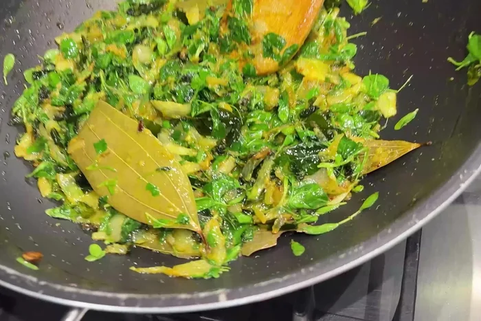 Add the chicken pieces to the kadai and fry until lightly browned on all sides. The chicken should release some fat during frying.
