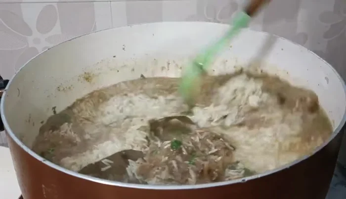 Add the soaked basmati rice (1kg, soaked for 1 hour), water (1 inch above the rice), green chilies, and lemon juice. Season with salt if needed.